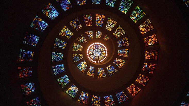 Spiral stained glass window ceiling from inside the prayer chapel of Thanksgiving Square in downtown Dallas, Texas.